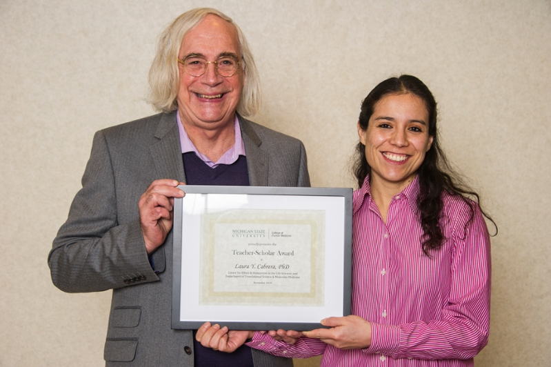 Leonard Fleck and Laura Cabrera hold the Teacher-Scholar award